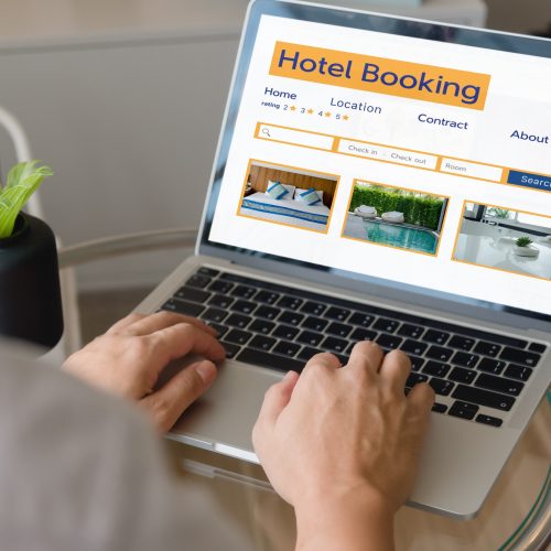 booking online concept, person using laptop computer planning travel search hotel booking.
